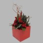 red flower arrangement in square vase 20 x 20 cm