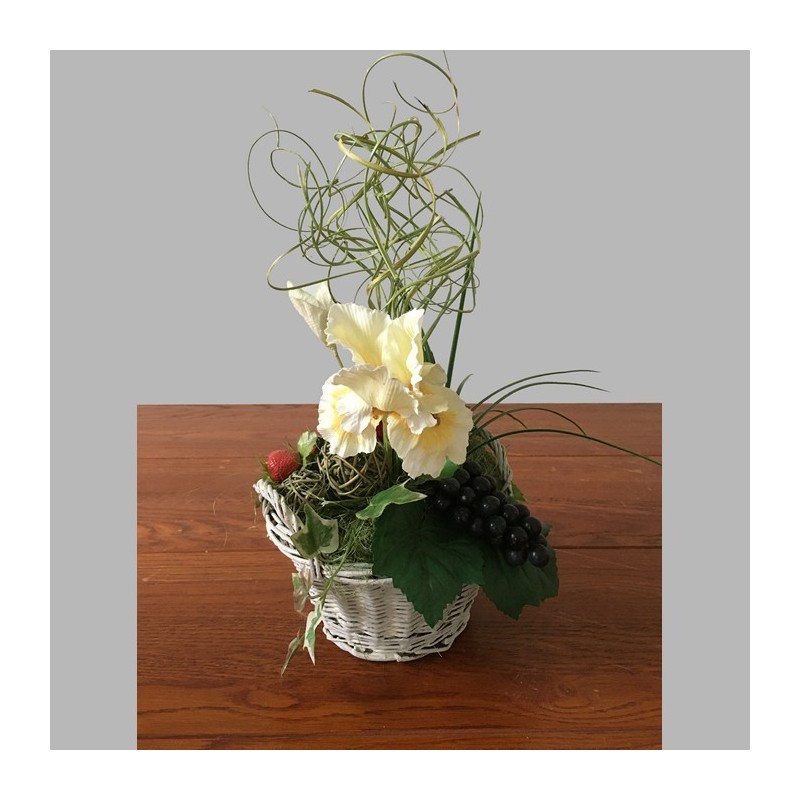 Flower arrangement with iris and grapes in basket