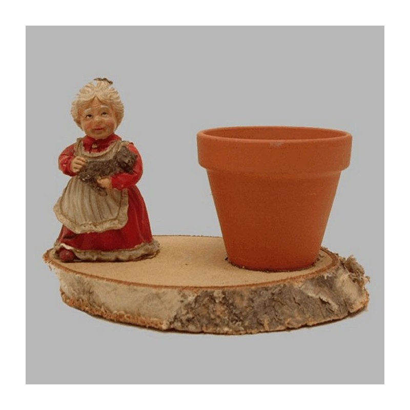 Flower pot with Lady of ceramic on tree bark