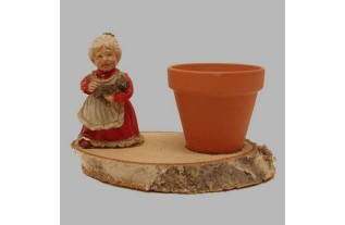 Flower pot with Lady of ceramic on tree bark