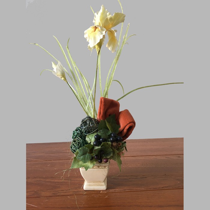 Flower arrangement with iris in a square ceramic pot