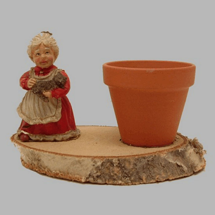 Flower pot with Lady of ceramic on tree bark